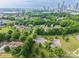 Aerial view showcasing proximity of homes, mature trees, and skyline in the distance at 1613 Hamilton St, Charlotte, NC 28206