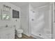 Bathroom featuring a single sink and a stand-up shower with white tile at 1613 Hamilton St, Charlotte, NC 28206