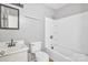 This bathroom has a single sink and a shower-tub combo with white tile at 1613 Hamilton St, Charlotte, NC 28206