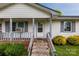 Inviting front porch with decorative rails, colorful bushes, and well-kept front yard at 1613 Hamilton St, Charlotte, NC 28206