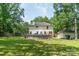 Spacious backyard with mature trees, above-ground pool, and storage shed at 1739 Lesa Lin Dr, Monroe, NC 28112