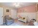 Well decorated Bedroom with pink walls, a white crib, and chair at 1739 Lesa Lin Dr, Monroe, NC 28112