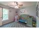 Bedroom with a green baby crib, a rocket tent, ceiling fan, and natural light at 1739 Lesa Lin Dr, Monroe, NC 28112