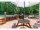 Deck featuring an umbrella covered picnic table, grill, barstools, and a pool at 1739 Lesa Lin Dr, Monroe, NC 28112