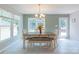 Bright dining area with large windows, stylish chandelier, and a table with seating for Gathering meals at 1739 Lesa Lin Dr, Monroe, NC 28112