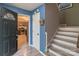 Entryway featuring painted blue walls, staircase, and view to the kitchen at 1739 Lesa Lin Dr, Monroe, NC 28112