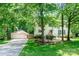 Charming home with mature trees, attached garage, and well-manicured lawn at 1739 Lesa Lin Dr, Monroe, NC 28112