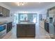 Open kitchen with island and view into the dining room at 1739 Lesa Lin Dr, Monroe, NC 28112