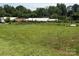 Large, grassy backyard with chain link fence and multiple outbuildings, offering ample space and potential at 1821 Beaman St, Shelby, NC 28152