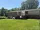 Backyard featuring a large grassy area and brick home with balcony at 1821 Beaman St, Shelby, NC 28152