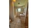 Functional bathroom features a shower-tub combo, vanity with tile countertop, and tile flooring at 1821 Beaman St, Shelby, NC 28152