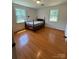 Bedroom with hardwood floors, two windows, and a bed at 1821 Beaman St, Shelby, NC 28152