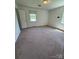 Bedroom with carpet flooring, one window, and a door at 1821 Beaman St, Shelby, NC 28152