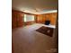Cozy living room with wood paneling, fireplace, carpet, and ample natural light, creating a warm and inviting atmosphere at 1821 Beaman St, Shelby, NC 28152