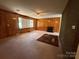 Cozy living room with wood paneling, fireplace, carpet, and ample natural light, creating a warm and inviting atmosphere at 1821 Beaman St, Shelby, NC 28152