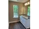 Charming bathroom featuring a double vanity with granite countertop and wood-look flooring at 183 Pine Haven Rd, Statesville, NC 28677