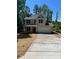 Charming two-story home featuring a long driveway, attached garage, and inviting covered front porch at 183 Pine Haven Rd, Statesville, NC 28677