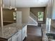 Kitchen island overlooking staircase and open floor plan with hardwood floors at 183 Pine Haven Rd, Statesville, NC 28677