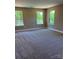 A spacious main bedroom offers plush carpeting and large windows providing natural light at 183 Pine Haven Rd, Statesville, NC 28677