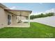 View of covered patio and backyard featuring green grass and white vinyl fence at 2021 Chantilly Ln, Salisbury, NC 28146