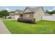 Well-kept home showcasing stone accents, a manicured lawn, and an attached two-car garage at 2021 Chantilly Ln, Salisbury, NC 28146