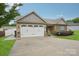 Charming single Gathering home features a two-car garage, stone accents and well-maintained landscaping at 2021 Chantilly Ln, Salisbury, NC 28146