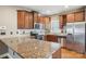 Spacious kitchen featuring granite countertops, stainless steel appliances, and ample wood cabinetry at 2021 Chantilly Ln, Salisbury, NC 28146