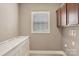 Laundry room featuring tile floors, a window, and a white folding table at 2021 Chantilly Ln, Salisbury, NC 28146
