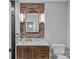 Bathroom featuring a vanity with stone countertop and exposed brick accents at 210 N Church St # 2910, Charlotte, NC 28202