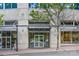 Modern building entrance features a glass door and transom with awning, street lamp, and sidewalk at 210 N Church St # 2910, Charlotte, NC 28202