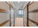 Bright hallway featuring hardwood floors and large windows with city views at 210 N Church St # 2910, Charlotte, NC 28202