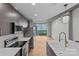 Modern kitchen boasts stainless steel appliances, island sink, and scenic city views at 210 N Church St # 2910, Charlotte, NC 28202