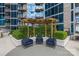 Outdoor seating area with pergola and landscaped greenery at 210 N Church St # 2910, Charlotte, NC 28202