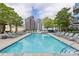 Outdoor pool with lounge chairs and city views at 210 N Church St # 2910, Charlotte, NC 28202