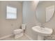 Neat half bathroom with sleek fixtures, vanity, and large round mirror at 2169 Shady Pond Dr, Clover, SC 29710
