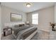 Neutral bedroom with carpet flooring, decorative lamps, and modern gray furnishings at 2169 Shady Pond Dr, Clover, SC 29710