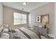 Bright bedroom with a window, neutral walls, and modern gray decor and stylish accents at 2169 Shady Pond Dr, Clover, SC 29710