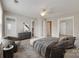 Spacious bedroom featuring a ceiling fan, sitting area, and modern gray furnishings at 2169 Shady Pond Dr, Clover, SC 29710