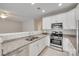 Well-lit kitchen featuring stainless steel appliances, white cabinets, and granite countertops at 2169 Shady Pond Dr, Clover, SC 29710