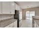 Kitchen with stainless steel refrigerator and an adjacent dining area with chandelier at 2169 Shady Pond Dr, Clover, SC 29710