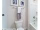 Clean white bathroom featuring a toilet, bathtub with shower and towel rack with towels at 221 Paige Rd, Kings Mountain, NC 28086
