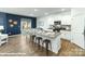 Modern kitchen featuring white cabinets, granite countertops, stainless steel appliances, and an island with barstool seating at 221 Paige Rd, Kings Mountain, NC 28086