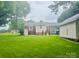 Spacious backyard showcasing a large lawn, covered parking, and an outbuilding at 2357 28Th Ne St, Hickory, NC 28601