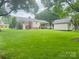 Expansive backyard featuring a well-maintained lawn, shed, and covered patio connected to the home at 2357 28Th Ne St, Hickory, NC 28601