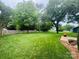 A large backyard with green grass, mature trees, and privacy fencing at 2357 28Th Ne St, Hickory, NC 28601