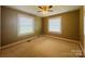 A spacious bedroom has two windows, carpet flooring, neutral paint, and a ceiling fan at 2357 28Th Ne St, Hickory, NC 28601