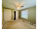 A carpeted bedroom features a ceiling fan, two closets, and a window with blinds at 2357 28Th Ne St, Hickory, NC 28601
