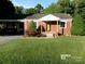 Charming brick home with a well-manicured lawn, carport, and inviting front porch at 2357 28Th Ne St, Hickory, NC 28601