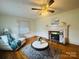Bright living room with hardwood floors, ceiling fan, fireplace, and comfortable seating at 2357 28Th Ne St, Hickory, NC 28601