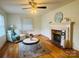 Bright living room featuring hardwood floors, a fireplace, ceiling fan and lots of natural light at 2357 28Th Ne St, Hickory, NC 28601
